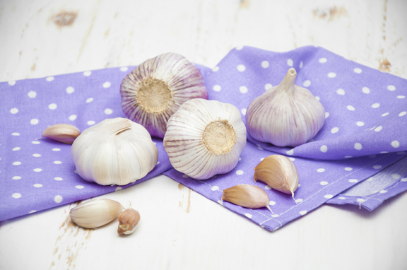 Garlic on a napkin on wooden background